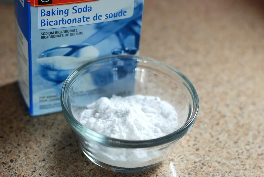 A variety of natural cleaning products sit in a bright and clean kitchen. baking soda, box, white-768950.jpg